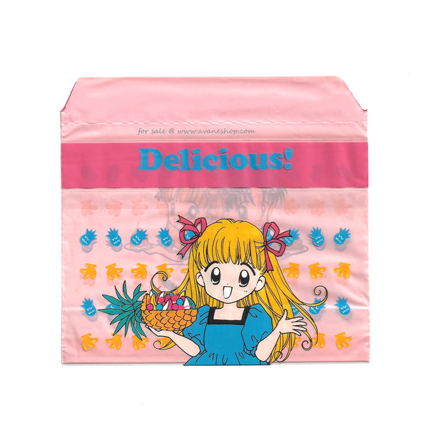 small pink bag featuring an image of an anime girl with a pineapple and other fruit from the 90s manga Delicious!