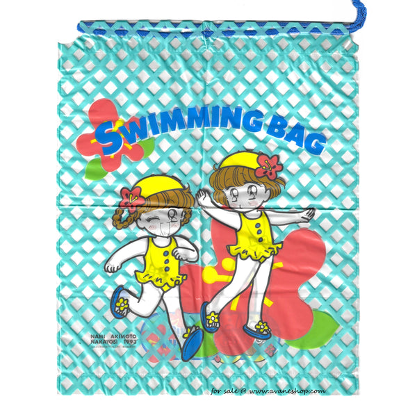 A Plastic bag with a blue lattice background and cute anime girls in yellow swimsuits from the Miracle Girls Manga in the foreground.