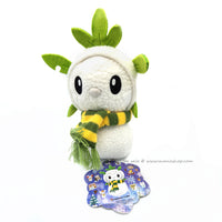 Chespin Snowman plush doll roughly 9 inches tall  with a green and yellow striped scarf. 