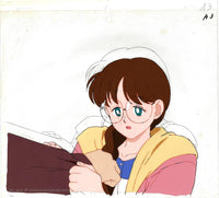 Han Painted anime cel from Sailor Moon. This is Yumemi Yumeno from episode 28, a girl with long brown braided hair, pale skin and glasses. She is wearing a pink and yellow jacket over a blue and white striped shirt. She is holding on to Mamarou's arm.