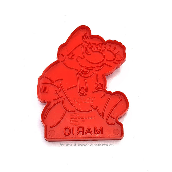 Vintage red plastic cookie cutter in the shape of mario  from the super mario brothers games