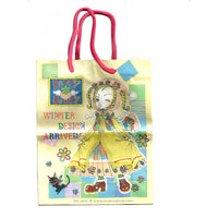 Yellow paper gift bag with anime manga style images of Ikako from Neighborhood story drawn by Ai Yazawa.
