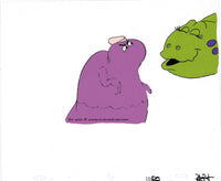 Animation cel froom the 80s pac man cartoon AKA Hanna Barbera's Pac-Man. This is the ghost Pinky disguised as a purple dinosaur about to be kissed by a green dinosaur.