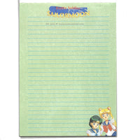 Green lined paper from a Japanese Sailor Moon Notebook from the 90s. In the corner are anime illustrations of Sailor Moon and Sailor Mercury.